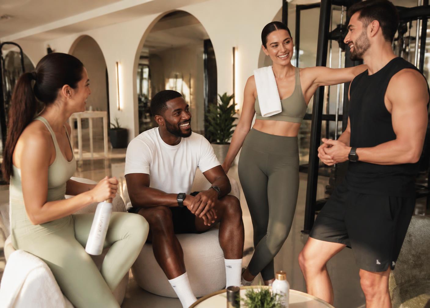 Gym members talking together after a training session in a boutique Dubai fitness club